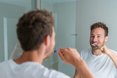 Why You Should Schedule Regular Dental Visits Man Brushing Teeth